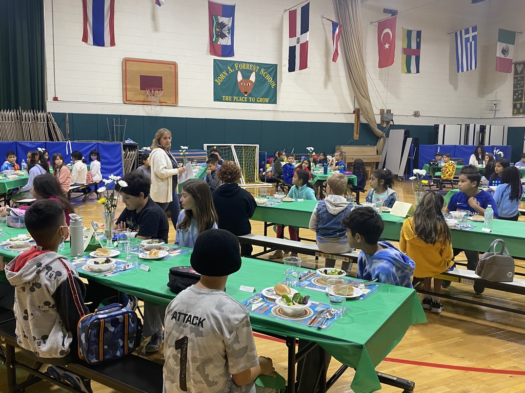 students in gym with green tablecloths