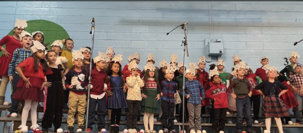 first grade classes singing at the holiday concert
