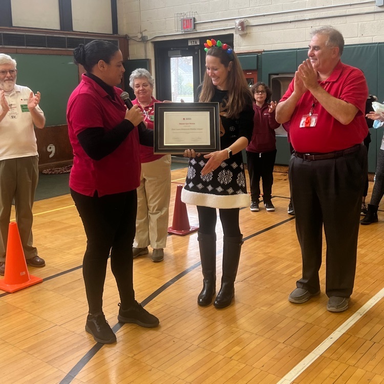 Principal, Nancy Schwindt, accepting a plaque on behalf of the Memorial community from the American Red Cross Disaster Cycle Services recognizing the generous donations Memorial has provided for the past 21 years  