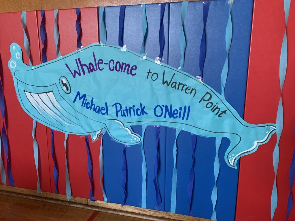 A cut out of a whale that says "Whale-come to Warren Point Michael Patrick O'Neill"
