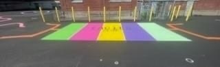 blacktop with green, pink, yellow, purple, and blue stripes painted on it