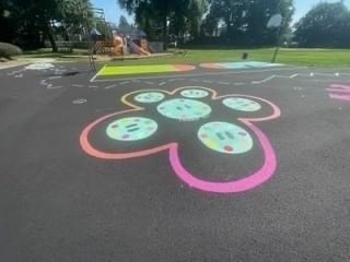 blacktop with multicolored flower painted on it