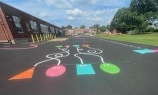 blacktop with multi colored shapes painted on it